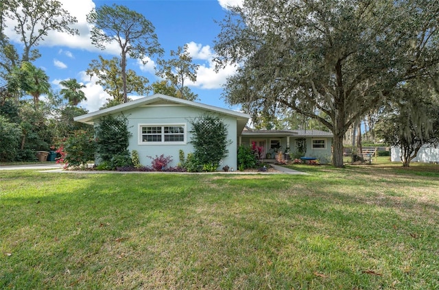 ranch-style home with a front lawn