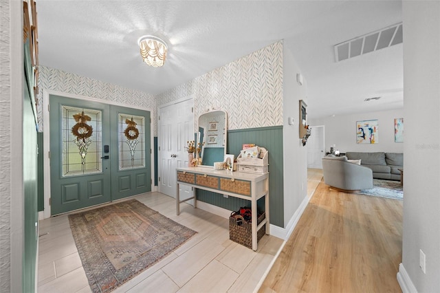 foyer with hardwood / wood-style flooring and a textured ceiling