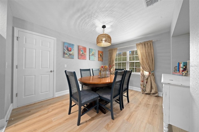 dining area with light hardwood / wood-style floors