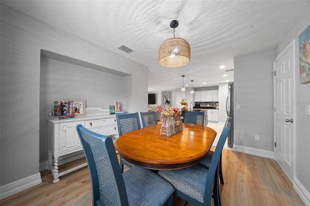 dining area with light hardwood / wood-style floors