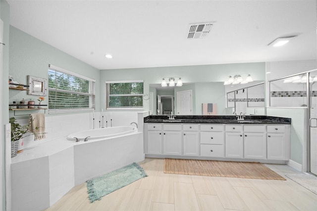 bathroom with shower with separate bathtub and vanity