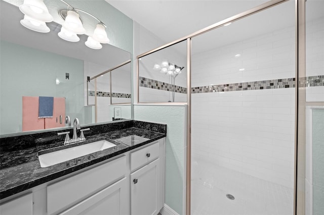 bathroom with vanity and a shower with shower door