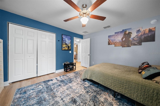 bedroom with a closet, ceiling fan, and light hardwood / wood-style flooring