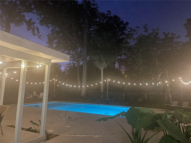 pool at twilight with a patio