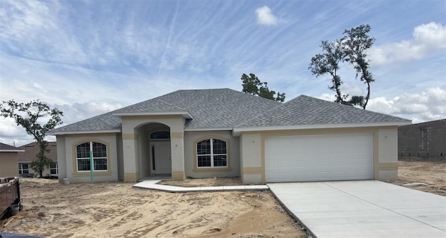 736 W Hallam Dr, Citrus Springs, FL 34434 - view of front facade featuring a shingled roof, stucco siding, an attached garage, and driveway