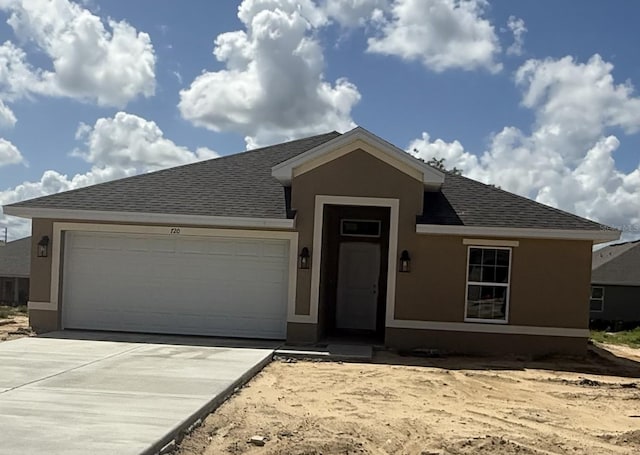 720 W Hallam Dr, Citrus Springs, FL 34434 - ranch-style house featuring roof with shingles, an attached garage, concrete driveway, and stucco siding