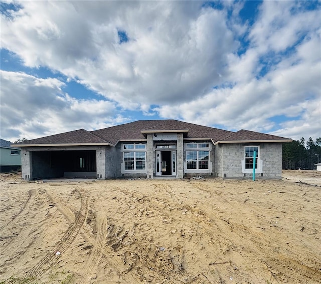 view of front of property featuring stone siding and an attached garage