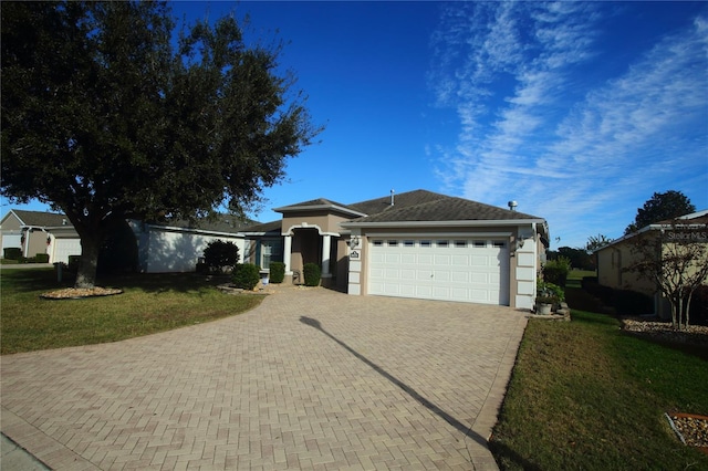 view of front of property featuring a garage and a front yard