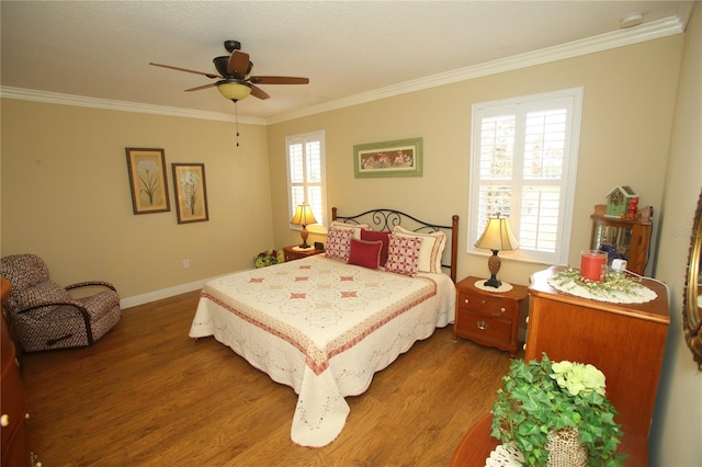 bedroom featuring ceiling fan, dark hardwood / wood-style floors, and crown molding