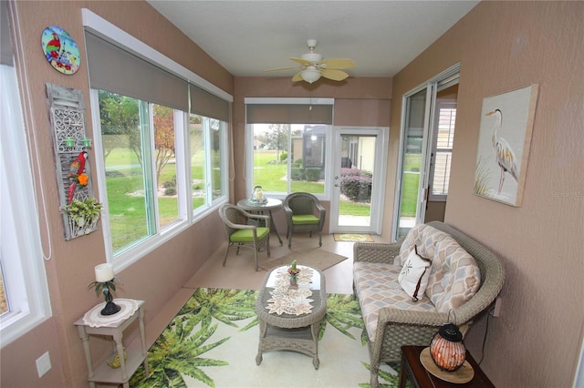 sunroom / solarium featuring plenty of natural light and ceiling fan