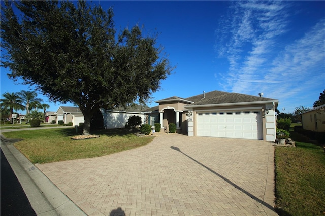 view of front of home with a front yard and a garage