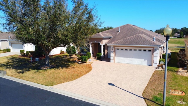 view of front of house with a garage and a front lawn