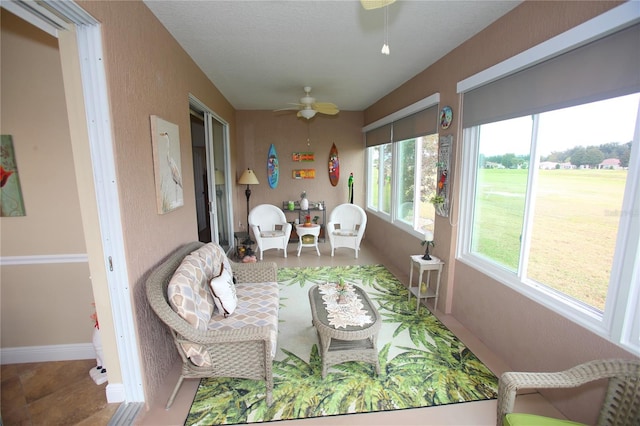 sunroom / solarium featuring ceiling fan