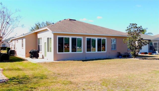 rear view of property featuring a lawn