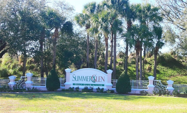 community sign featuring a lawn