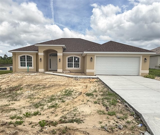 single story home featuring stucco siding, a garage, and concrete driveway