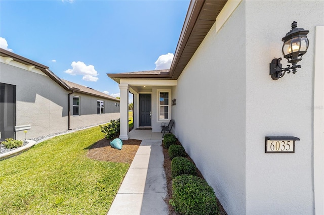 doorway to property featuring a yard