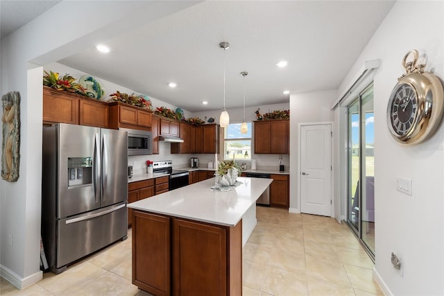 kitchen with pendant lighting, a center island, light tile patterned floors, and appliances with stainless steel finishes