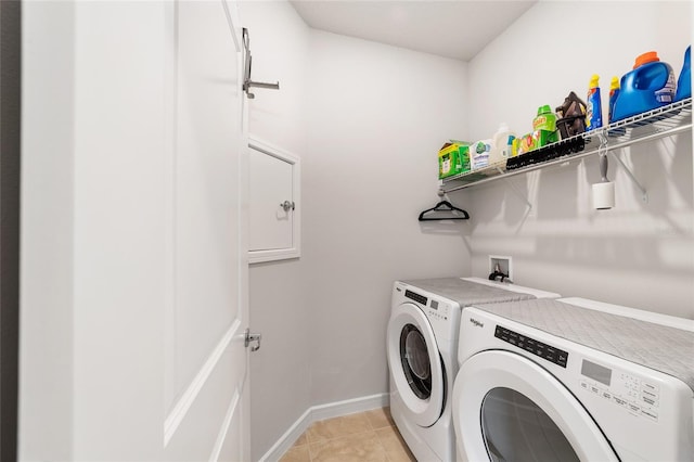 washroom with light tile patterned floors and washing machine and clothes dryer