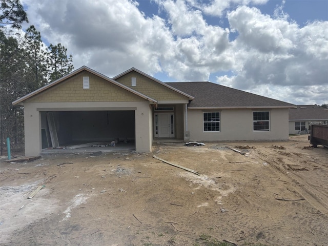 view of front of house featuring an attached garage and stucco siding