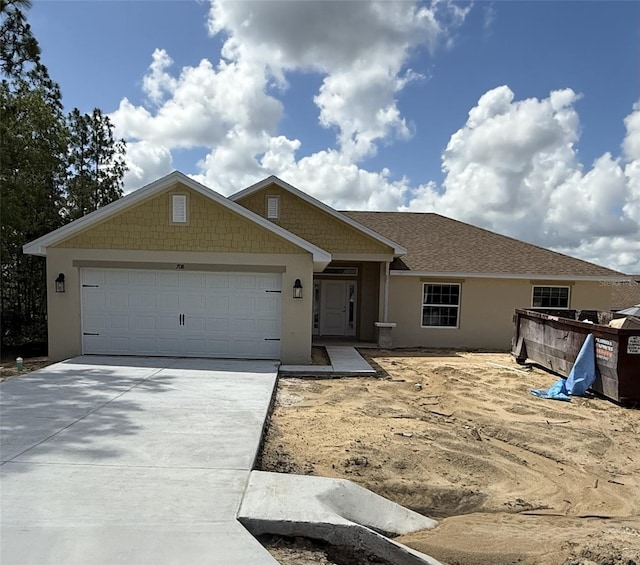 708 W Hallam Dr, Citrus Springs, FL 34434 - view of front of home featuring concrete driveway, an attached garage, and stucco siding