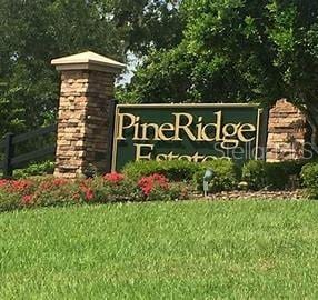 community sign featuring a lawn