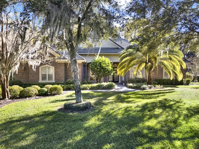 obstructed view of property featuring a front yard