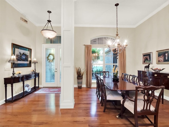 interior space with wood-type flooring, ornamental molding, and a notable chandelier