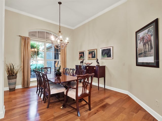 dining area featuring a chandelier, hardwood / wood-style floors, and crown molding