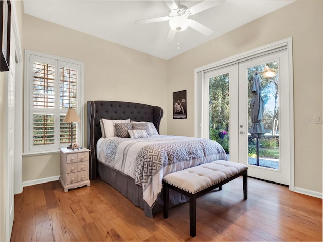 bedroom with access to exterior, light hardwood / wood-style flooring, multiple windows, and ceiling fan