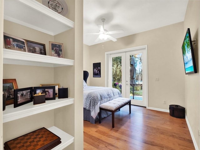 bedroom featuring access to exterior, french doors, hardwood / wood-style flooring, and ceiling fan