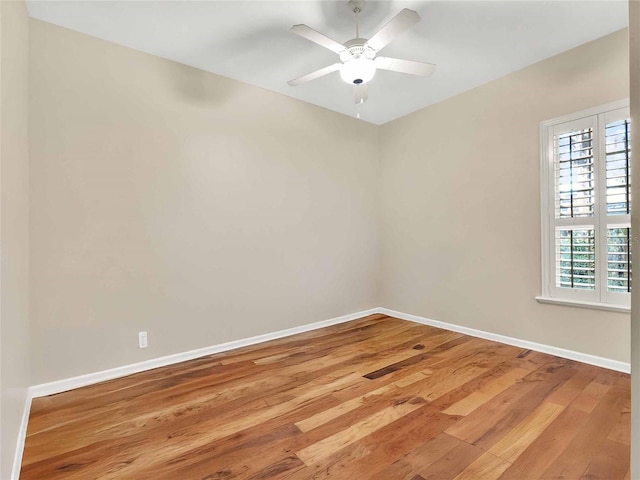 empty room with ceiling fan and wood-type flooring