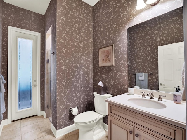 bathroom featuring toilet, vanity, and tile patterned floors