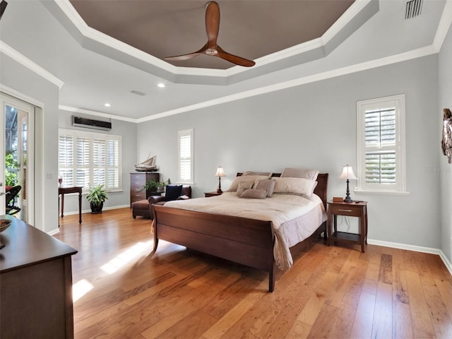 bedroom featuring multiple windows, ceiling fan, light hardwood / wood-style floors, and ornamental molding