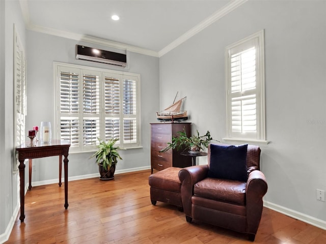 living area featuring an AC wall unit, ornamental molding, a healthy amount of sunlight, and light wood-type flooring