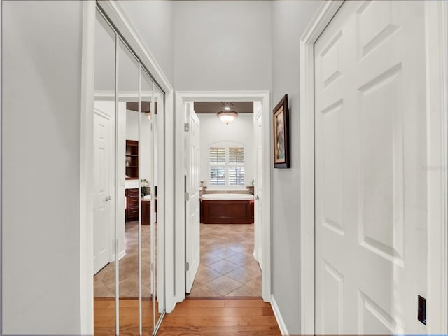 hall with hardwood / wood-style floors