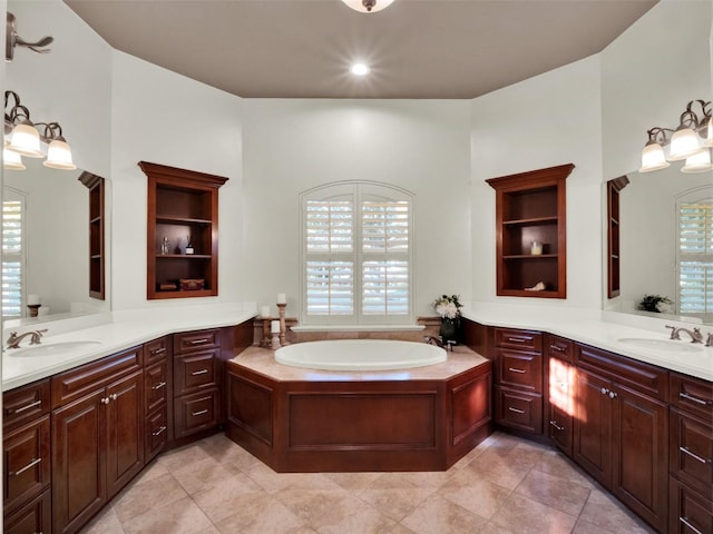 bathroom featuring a washtub, vanity, and a wealth of natural light