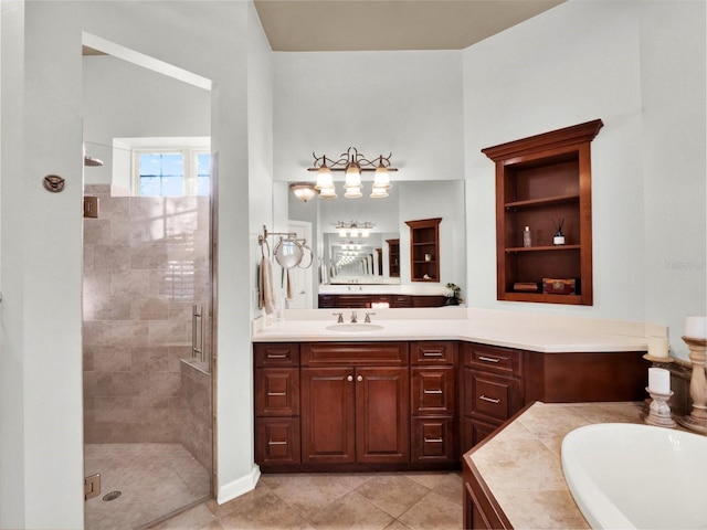 bathroom featuring plus walk in shower, vanity, and tile patterned floors