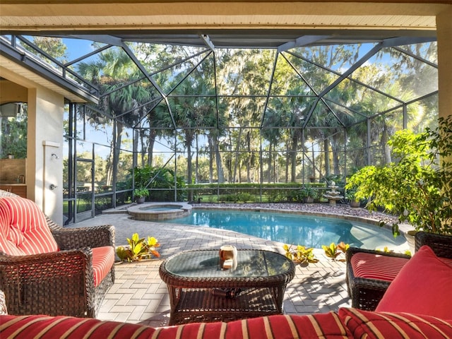 view of swimming pool featuring glass enclosure, an in ground hot tub, and a patio