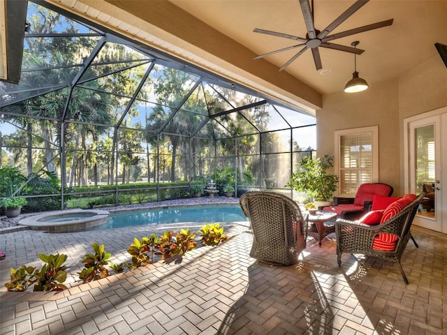 view of pool featuring a lanai, a patio area, an in ground hot tub, and ceiling fan