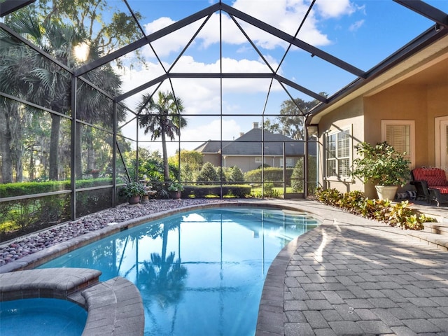 view of swimming pool with a lanai, a patio, and an in ground hot tub