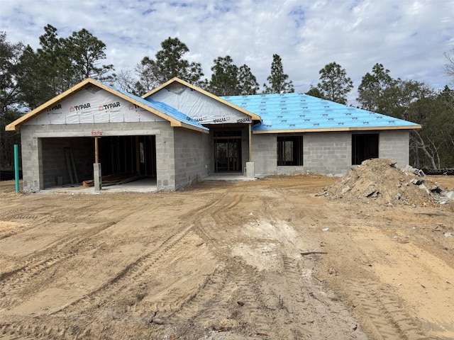 unfinished property with a garage