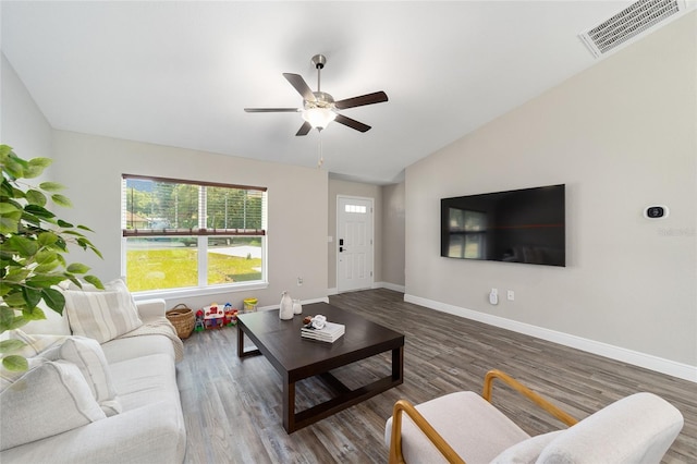 living room with ceiling fan, lofted ceiling, and dark wood-type flooring