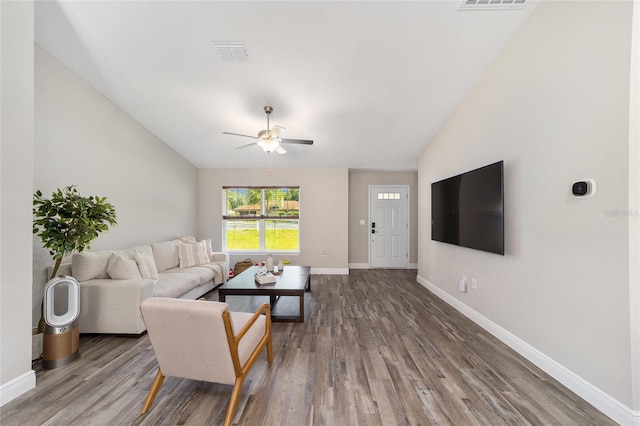 living room with hardwood / wood-style floors, vaulted ceiling, and ceiling fan