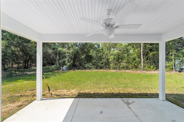 view of yard featuring ceiling fan and a patio