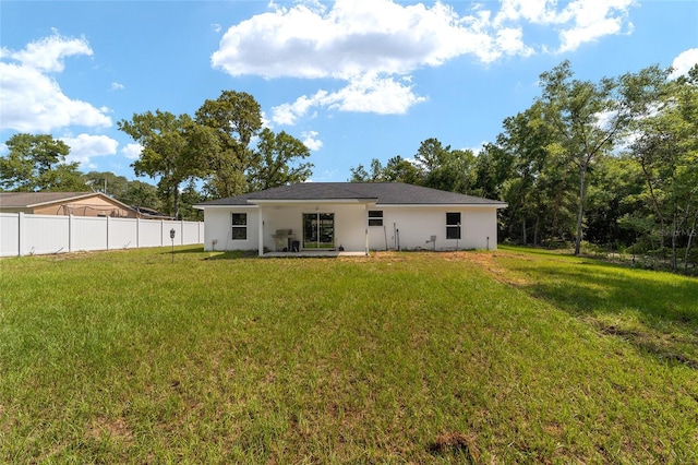 rear view of house with a lawn