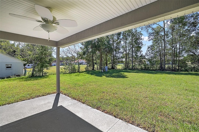 view of yard with a ceiling fan and a patio