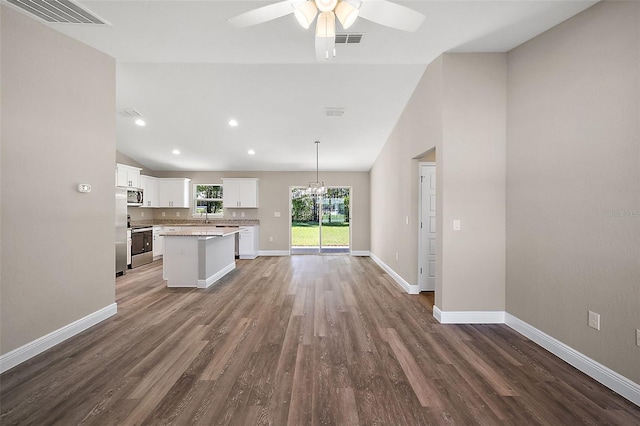 kitchen featuring visible vents, a kitchen island, stainless steel appliances, light countertops, and white cabinetry