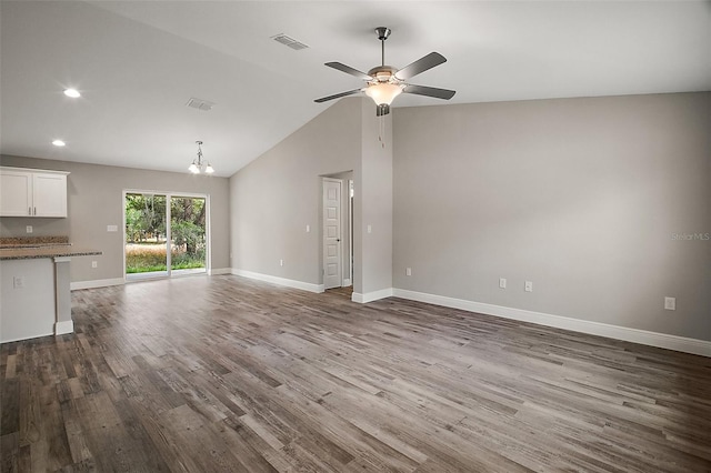 unfurnished living room with recessed lighting, ceiling fan with notable chandelier, dark wood-style flooring, baseboards, and visible vents