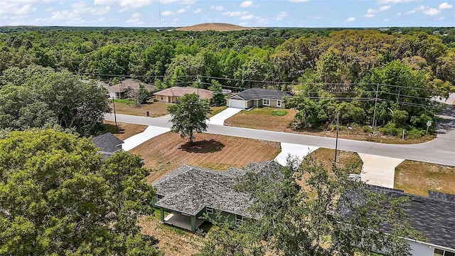 birds eye view of property with a view of trees